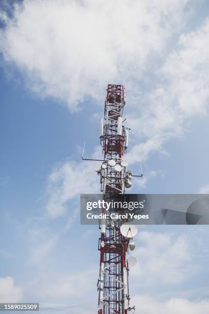 telecommunication mast with microwave link and tv transmitter antennas over a blue sky. - clear channel stock pictures, royalty-free photos & images