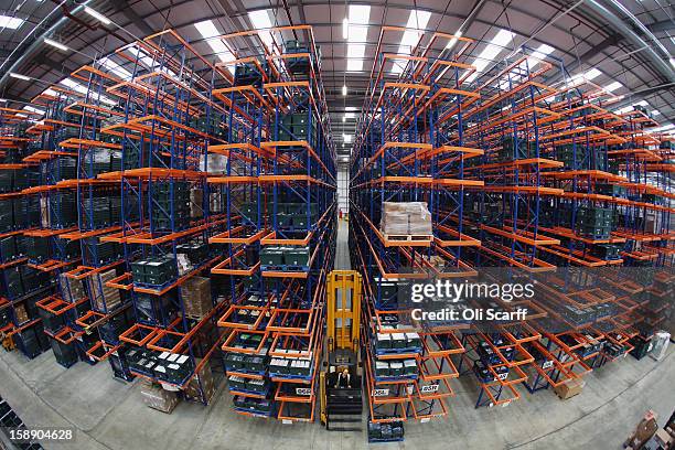 Worker rides a lift in the giant semi-automated distribution centre where the company's partners process the online orders for the John Lewis...