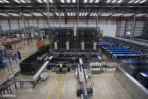 Worker handles an item in the giant semi-automated distribution centre where the company's partners process the online orders for the John Lewis...