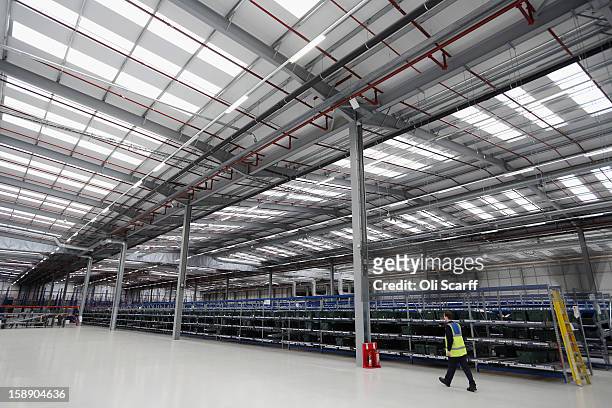 Worker walks in the giant semi-automated distribution centre where the company's partners process the online orders for the John Lewis department...