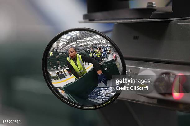 Mirror reflects a worker in the giant semi-automated distribution centre where the company's partners process the online orders for the John Lewis...