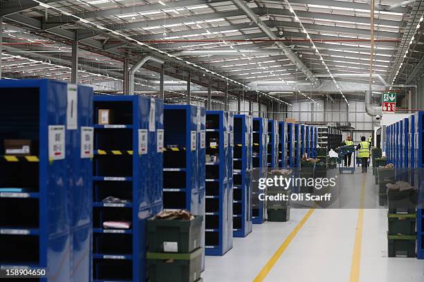 Worker moves a cart in the giant semi-automated distribution centre where the company's partners process the online orders for the John Lewis...