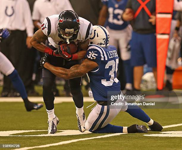 DeVier Posey of the Houston Texans is hit by Joe Lefeged of the Indianapolis Colts at Lucas Oil Stadium on December 30, 2012 in Indianapolis,...