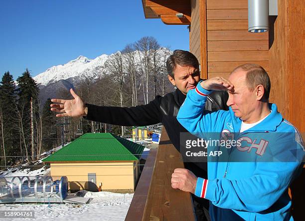 Russian President Vladimir Putin speaks with Alexander Tkachev , Krasnodar region Governor, during a visit to the mountain resort in Krasnaya Polyana...