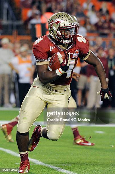 Lonnie Pryor of the Florida State Seminoles carries the ball against the Northern Illinois Huskies during the Discover Orange Bowl at Sun Life...