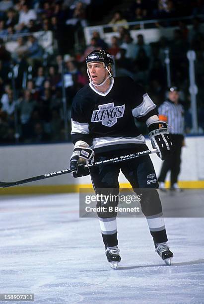 Bernie Nicholls of the Los Angeles Kings skates on the ice during an NHL game against the New York Islanders on December 10, 1988 at the Nassau...