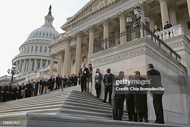 Nearly a year after suffering an major stroke, U.S. Sen. Mark Kirk waves to friends and supporters as he marks his return to the Senate by walking up...