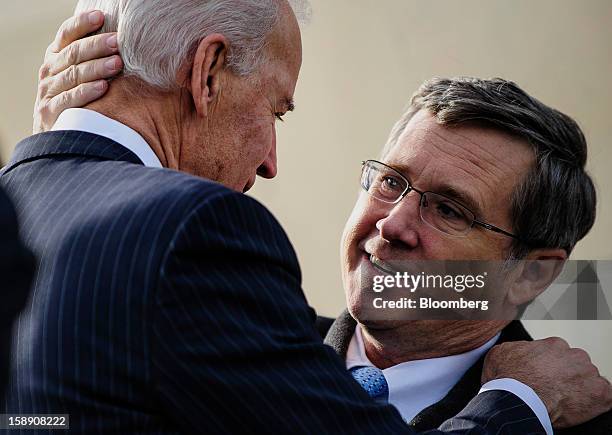 Vice President Joseph "Joe" Biden, left, greets Senator Mark Kirk, a Republican from Illinois, on the steps of the U.S. Capitol in Washington, D.C.,...