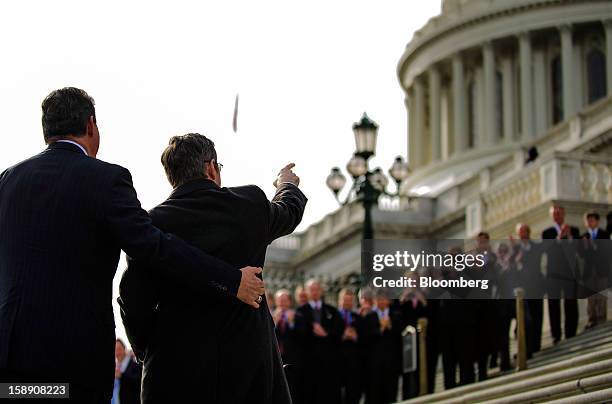 Senator Mark Kirk, a Republican from Illinois, front right, gestures while standing on the steps of the U.S. Capitol in Washington, D.C., U.S., on...