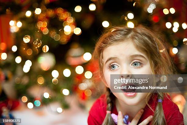 young girl singing christmas carol - singing stock-fotos und bilder