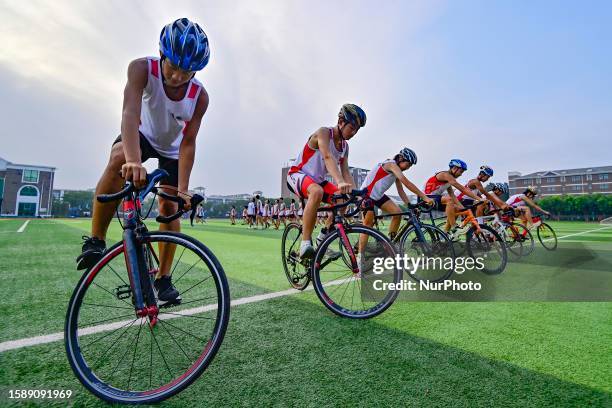 Students carry out bicycle training on the playground of Qicheng Education Group in Qingzhou city, East China's Shandong Province, Aug 10, 2023....