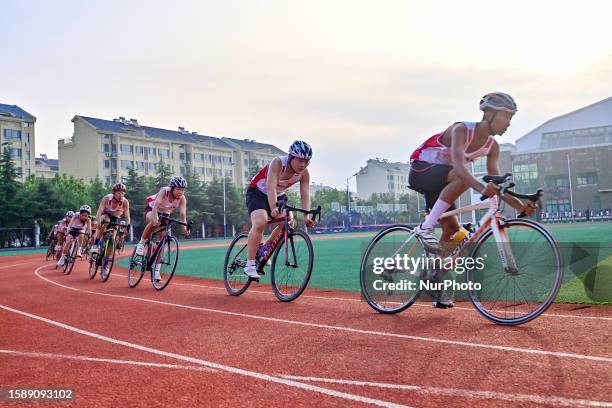 Students carry out bicycle training on the playground of Qicheng Education Group in Qingzhou city, East China's Shandong Province, Aug 10, 2023....