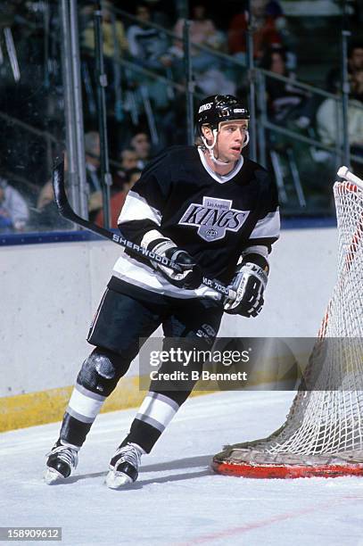 Bernie Nicholls of the Los Angeles Kings skates on the ice during an NHL game against the New York Islanders on December 10, 1988 at the Nassau...