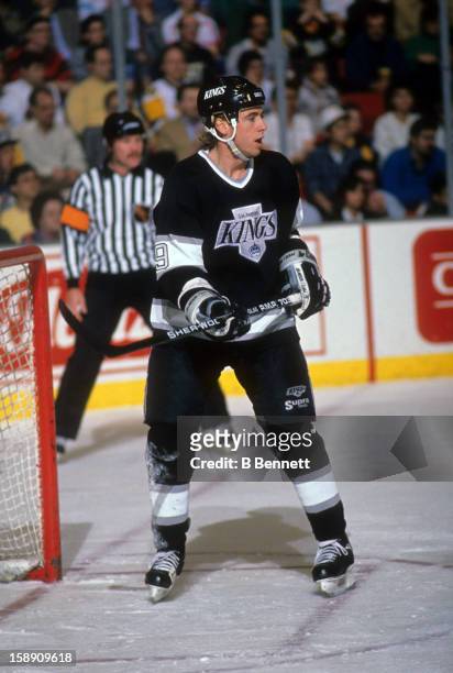 Bernie Nicholls of the Los Angeles Kings stands in front of the net during an NHL game against the Pittsburgh Penguins on December 14, 1988 at the...
