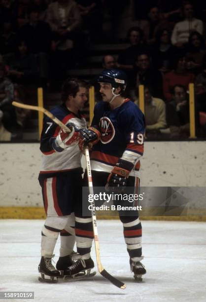 Bryan Trottier of the New York Islanders battles with Rod Gilbert of the New York Rangers on November 12, 1978 at the Madison Square Garden in New...