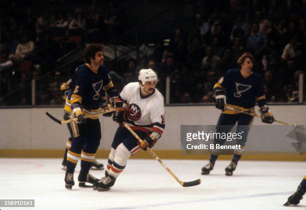 Bryan Trottier of the New York Islanders battles with Larry Giroux of the St. Louis Blues during their game on February 22, 1979 at the Nassau...