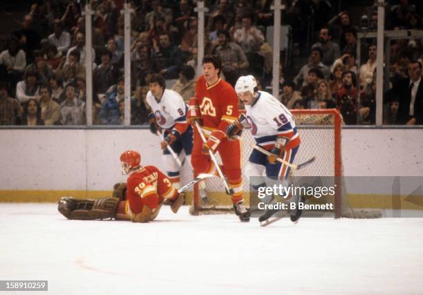 Bryan Trottier of the New York Islanders skates on the ice with Brad Marsh of the Atlanta Flames on March 3, 1979 at the Nassau Coliseum in...