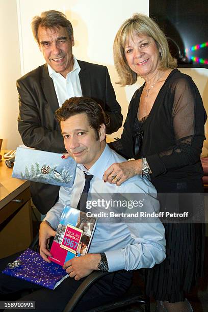 French impersonator Laurent Gerra , who turned 45 on December 29, holds some of his birthday presents as he poses with his mother Nicole and father...