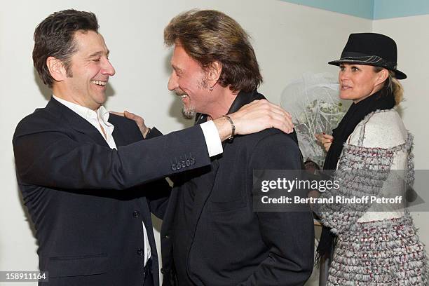 French impersonator Laurent Gerra shares a light moment with French rocker Johnny Hallyday as Hallyday's wife Laeticia looks on, in Gerra's dressing...