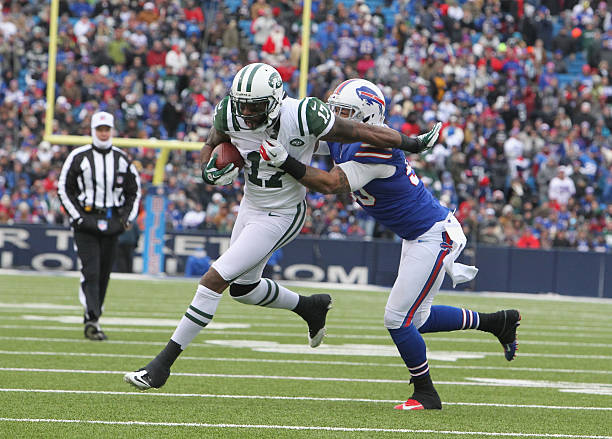 Wide Receiver Braylon Edwards of the New York Jets makes a catch and battles Linebacker Nick Barnett of the Buffalo Bills when the Buffalo Bills host...