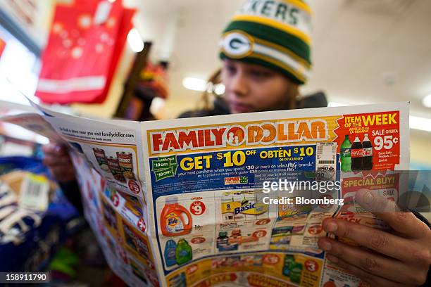 Shopper Mandy Prevello, of East Orange, New Jersey, reads a Family Dollar Stores Inc. Advertisement at a store in Belleville, New Jersey, U.S., on...