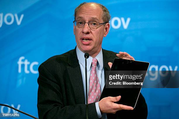 Jon Leibowitz, chairman of the Federal Trade Commission , holds up an Apple Inc. IPad during a news conference in Washington, D.C., U.S., on...