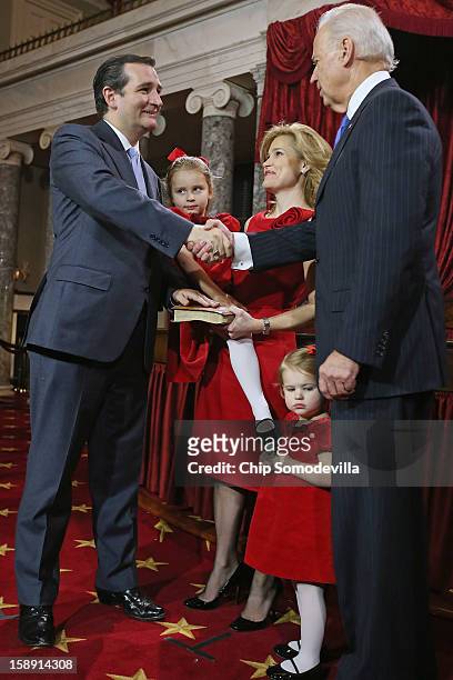 Sen. Ted Cruz participates in a reenacted swearing-in with his wife Heidi Nelson Cruz, daughters Caroline and Catherine, and U.S. Vice President Joe...