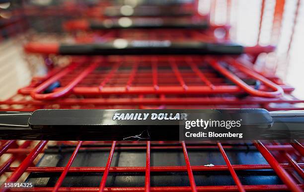 Family Dollar Stores Inc. Signage is displayed on a shopping cart at a store in Belleville, New Jersey, U.S., on Thursday, Jan. 3, 2013. Family...