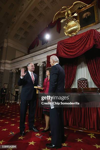 Sen. Tim Kaine participates in a reenacted swearing-in with his wife Anne Bright Holton and U.S. Vice President Joe Biden in the Old Senate Chamber...