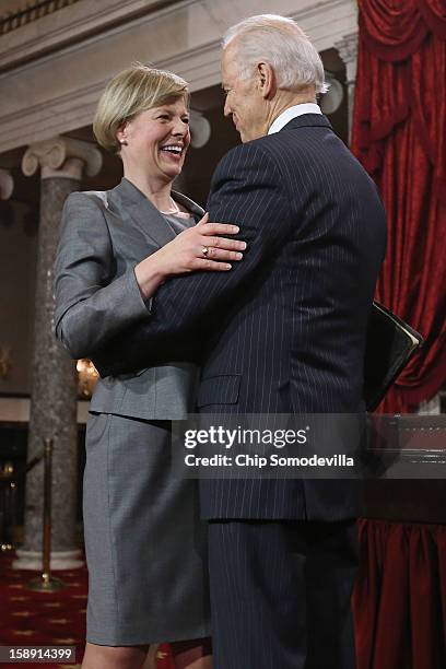 Sen. Tammy Baldwin embraces U.S. Vice President Joe Biden before participating in a reenacted swearing-in in the Old Senate Chamber at the U.S....