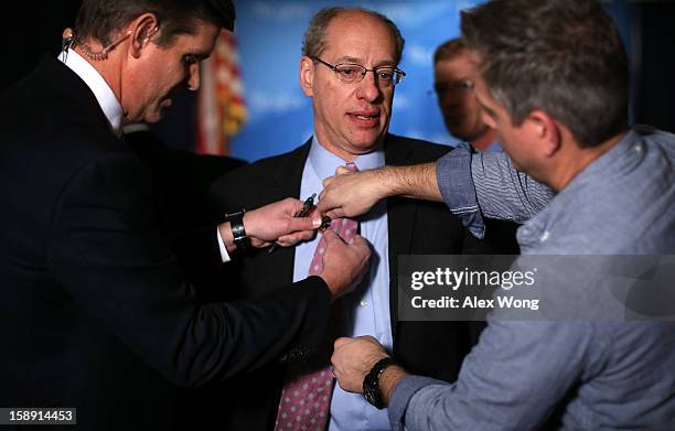 Federal Trade Commission Chairman Jon Leibowitz is prepared by members of a TV crew for an interview after a news conference regarding the agency’s...