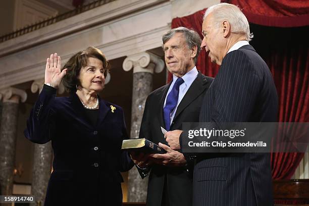 Sen. Dianne Feinstein participates in a reenacted swearing-in with her husband Richard C. Blum and U.S. Vice President Joe Biden in the Old Senate...