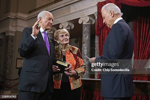 Sen. Orrin Hatch participates in a reenacted swearing-in with his wife Elaine Hatch and U.S. Vice President Joe Biden in the Old Senate Chamber at...