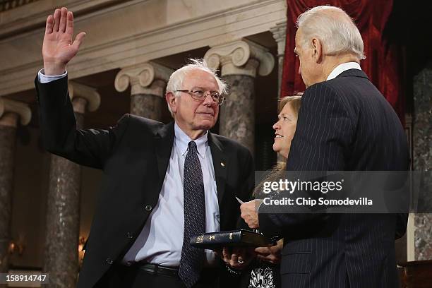 Sen. Bernie Sanders participates in a reenacted swearing-in with his wife Jane OÕMeara Sanders and U.S. Vice President Joe Biden in the Old Senate...