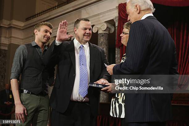 Sen. John Tester participates in a reenacted swearing-in with his wife Sharla Tester, son Shon Tester and U.S. Vice President Joe Biden in the Old...