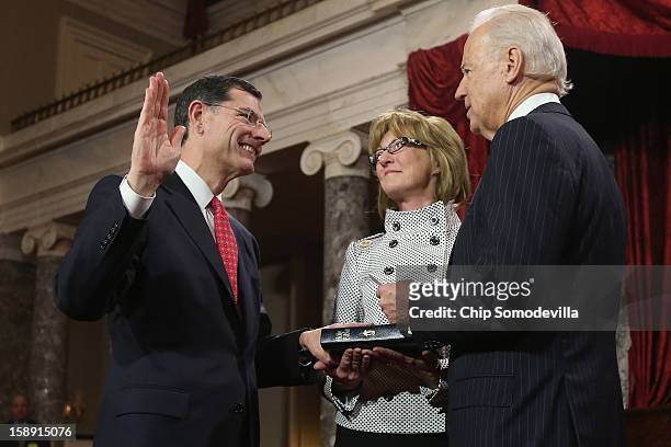 Sen. John Barrasso participates in a reenacted swearing-in with his wife Bobbi Brown and U.S. Vice President Joe Biden in the Old Senate Chamber at...