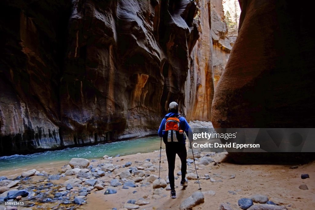 Man hiking in The Narrows in Zion National Park