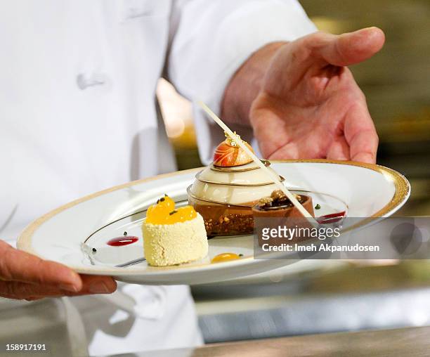 Preview of the cappuccino mousse dome, orange sanguine and chocolate salted caramel dessert prepared by executive pastry chef Thomas Henzi for the...
