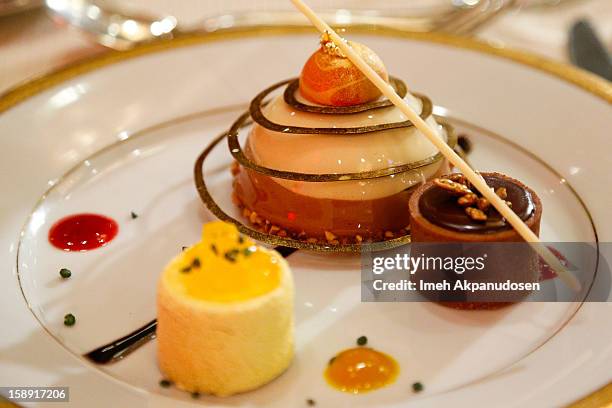 Preview of the cappuccino mousse dome, orange sanguine and chocolate salted caramel dessert prepared by executive pastry chef Thomas Henzi for the...