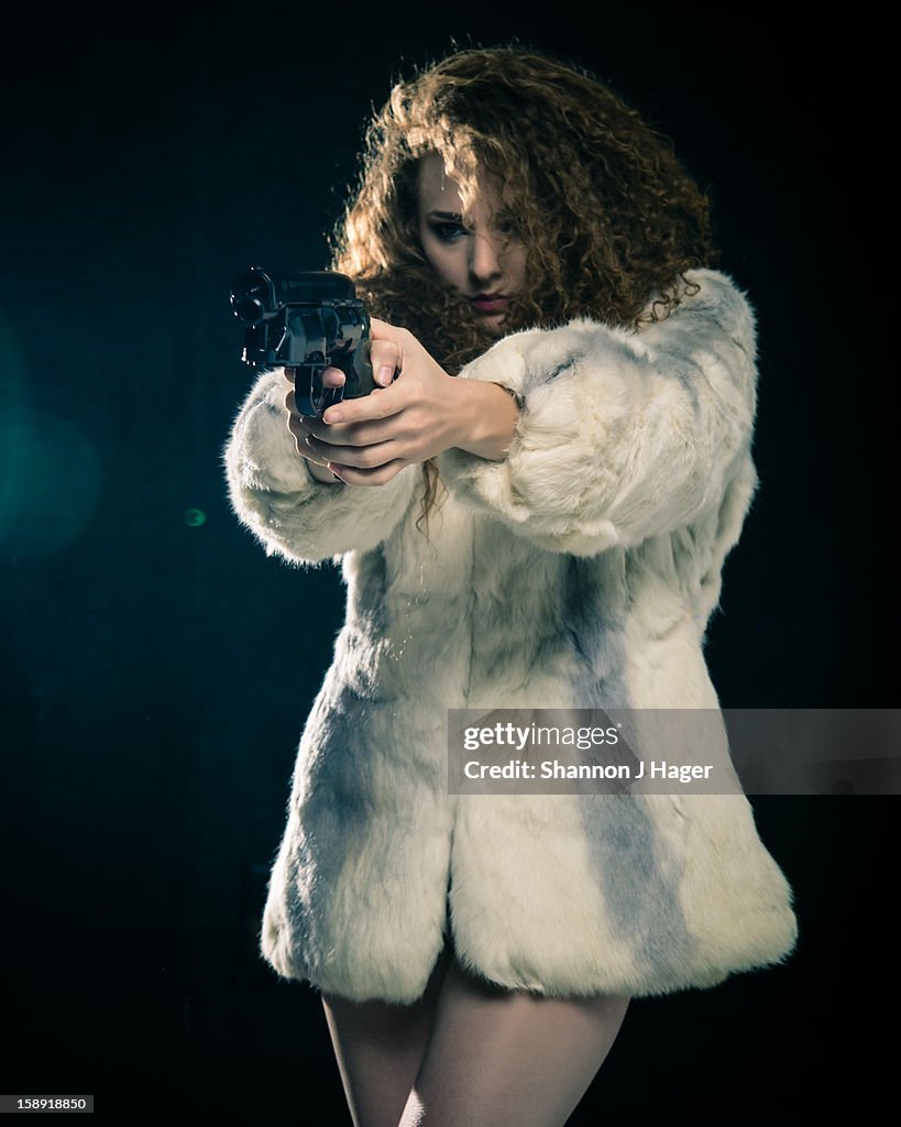 Girl in Fur Coat Pointing a Gun