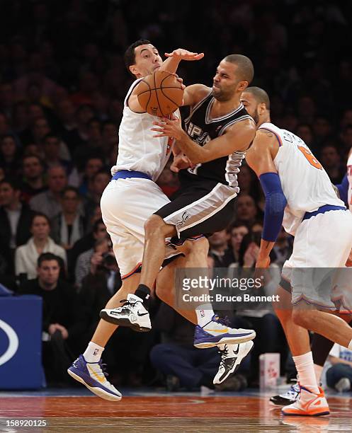 Pablo Prigioni of the New York Knicks collides with Tony Parker of the San Antonio Spurs at Madison Square Garden on January 3, 2013 in New York...