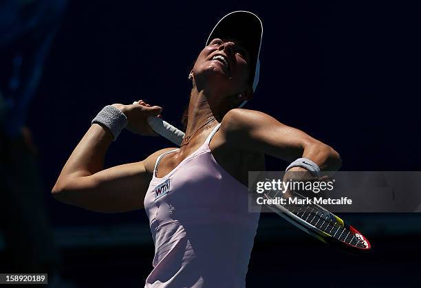 Mandy Minella of Luxembourg serves in her qualifying singles match with Rebecca Marino of Canada during day one of the Hobart International at Domain...