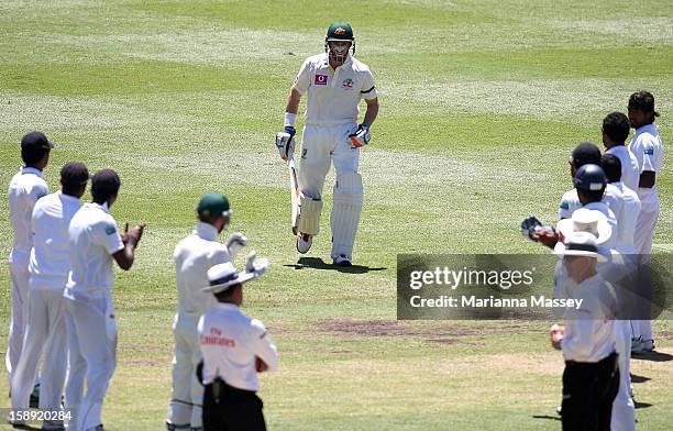 Michael Hussey of Australia walks out to bat through a guard of honour formed by the Sri Lankans during his last test during day two of the Third...