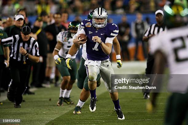 Collin Klein of the Kansas State Wildcats carries the ball against the Oregon Ducks during the Tostitos Fiesta Bowl at University of Phoenix Stadium...