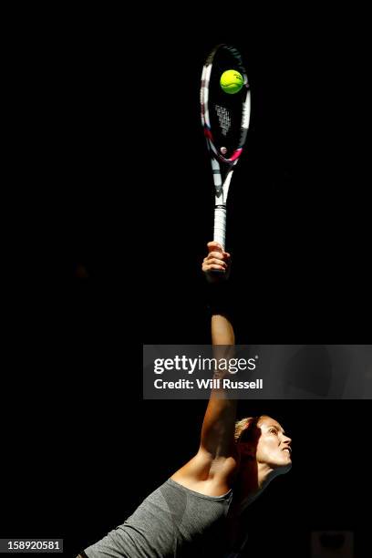 Mathilde Johansson of France serves in her singles match against Chanelle Scheepers of South Africa during day seven of the Hopman Cup at Perth Arena...