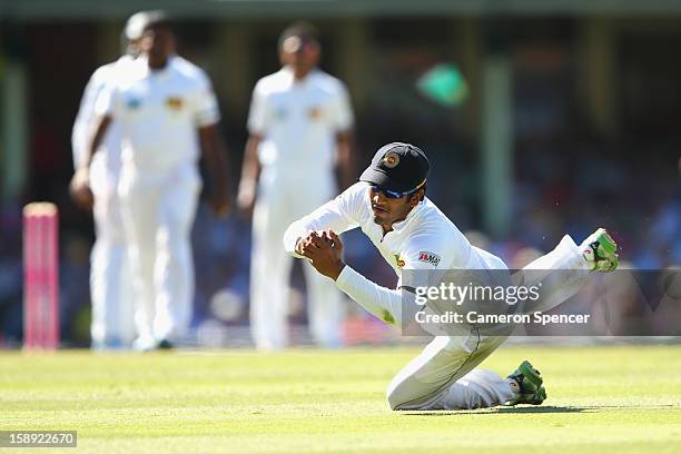 Dimuth Karunaratne catches out Australian captain Michael Clarke off a delivery by Rangana Herath of Sri Lanka during day two of the Third Test match...
