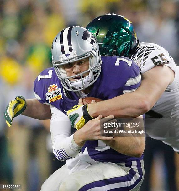 Kansas State quarterback Collin Klein is stopped by Oregon defensive tackle Taylor Hart late in the third quarter in the Tostitos Fiesta Bowl at the...