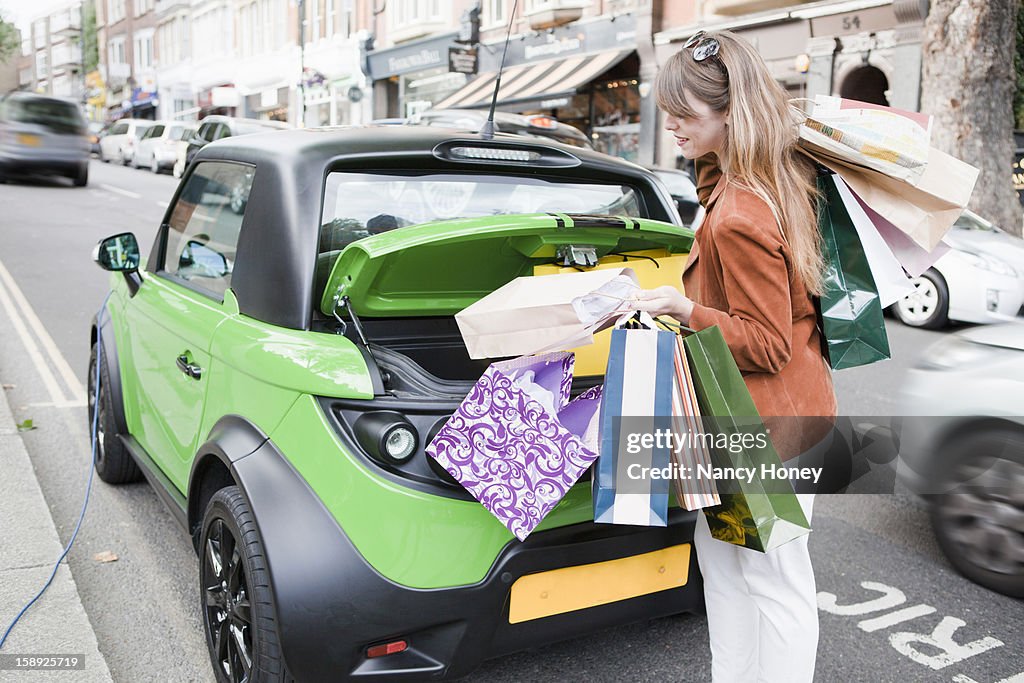 Woman loading shopping bags in car