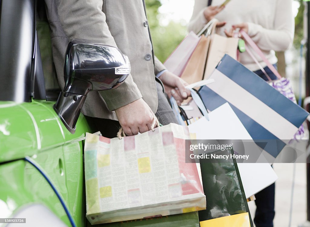 Couple loading shopping bags in car