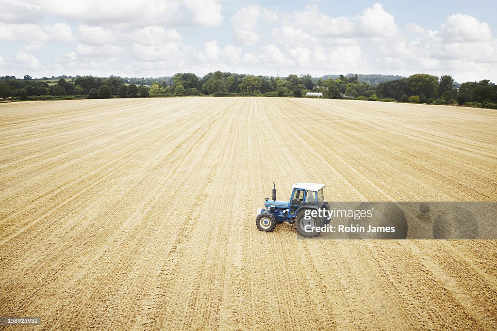 Tractors parked in tilled crop field